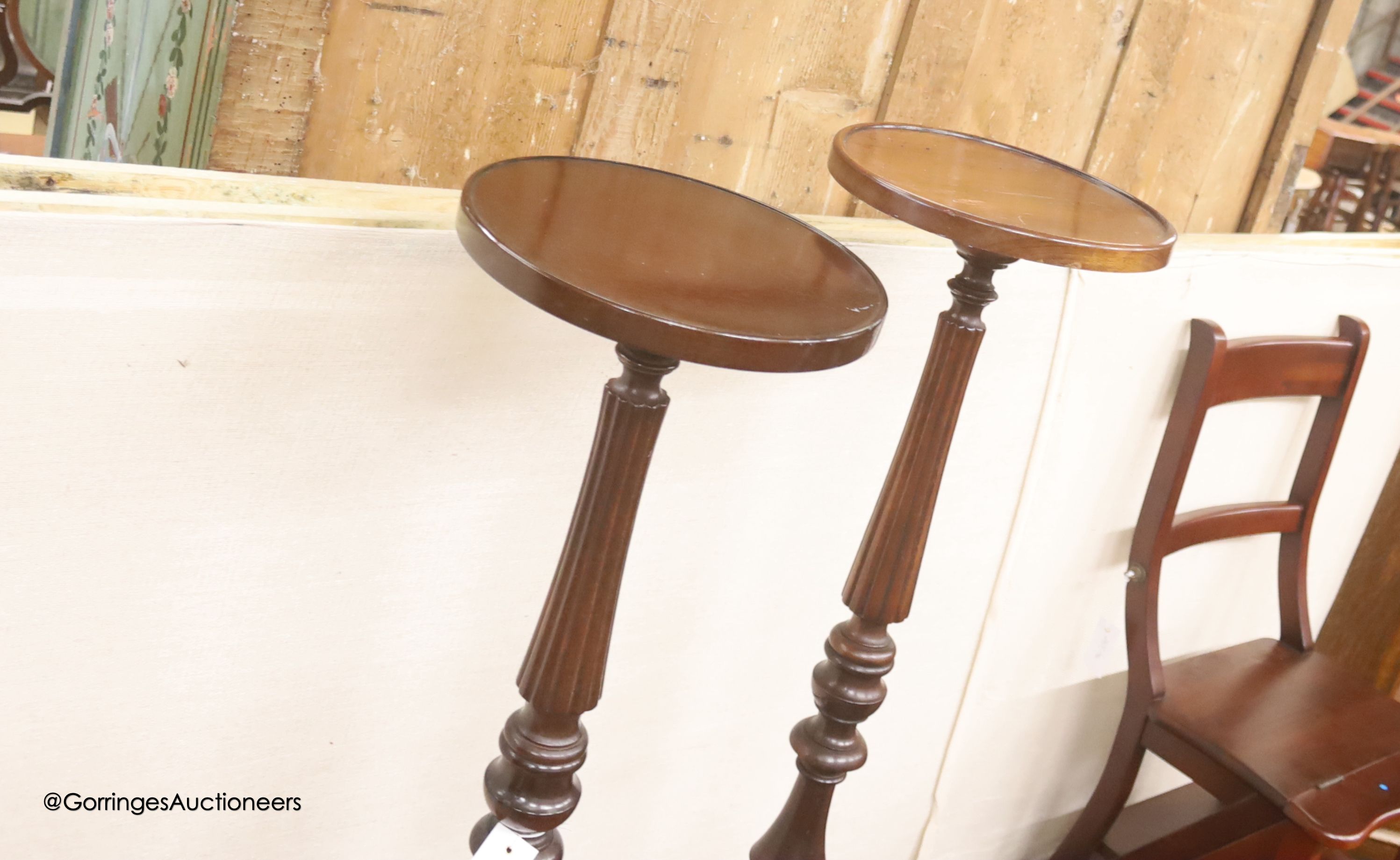 A near pair of reproduction mahogany torcheres, larger 100cm high
